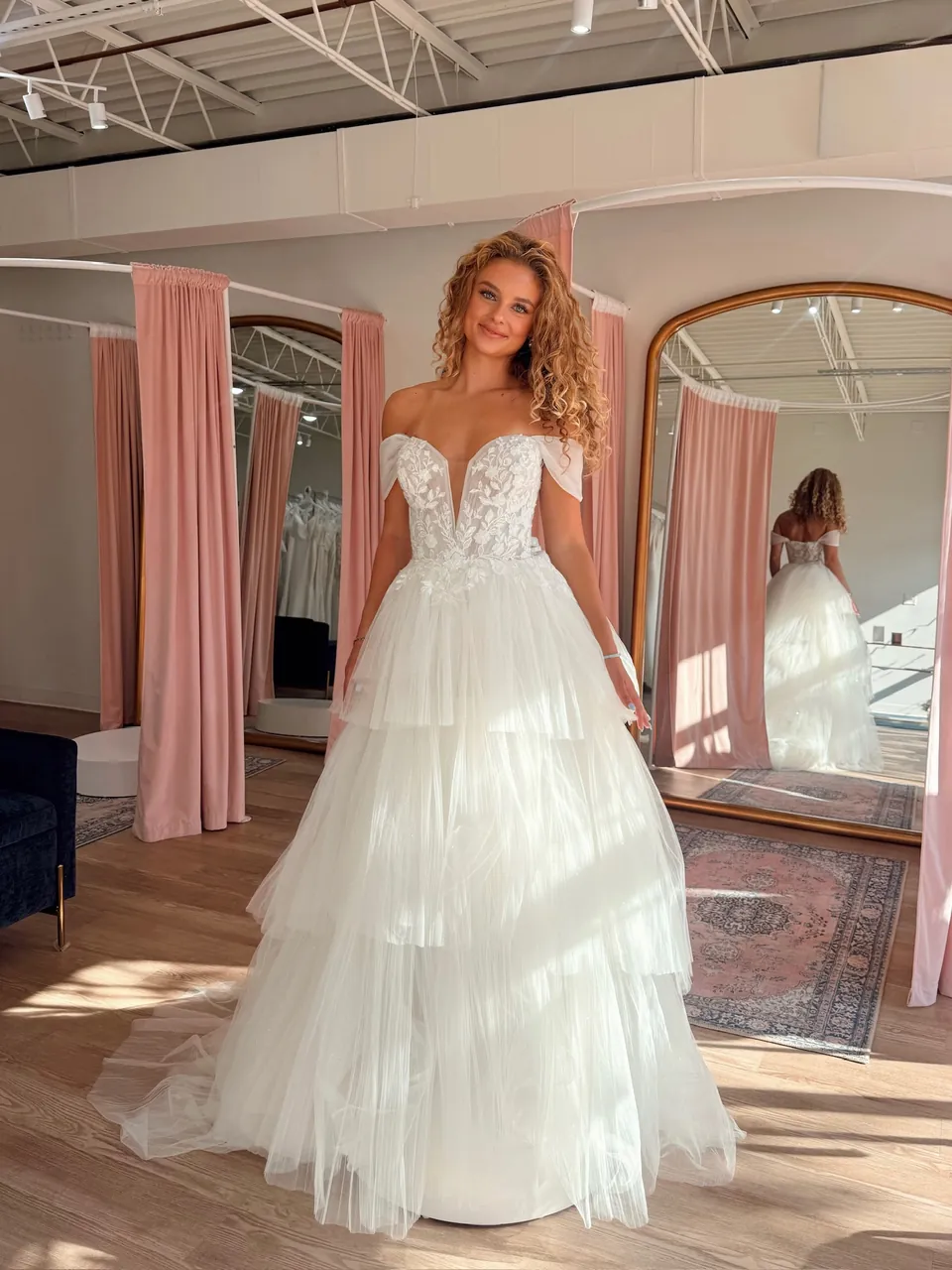 Strapless lace wedding dress with a plunging sweetheart neckline and tiered tulle skirt