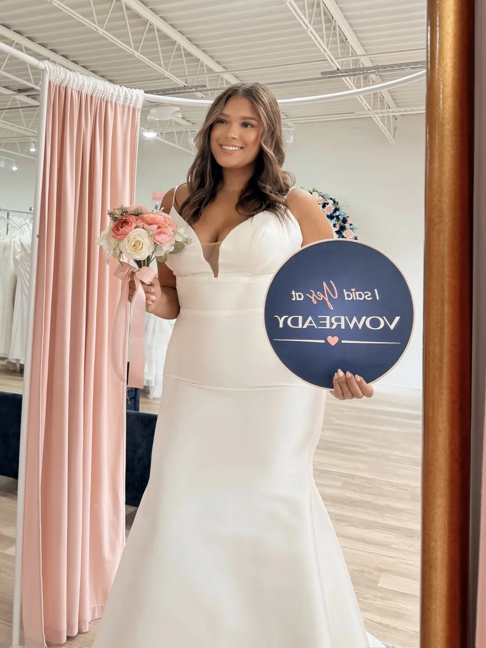 A Vow Ready bride holding an I said yes sign