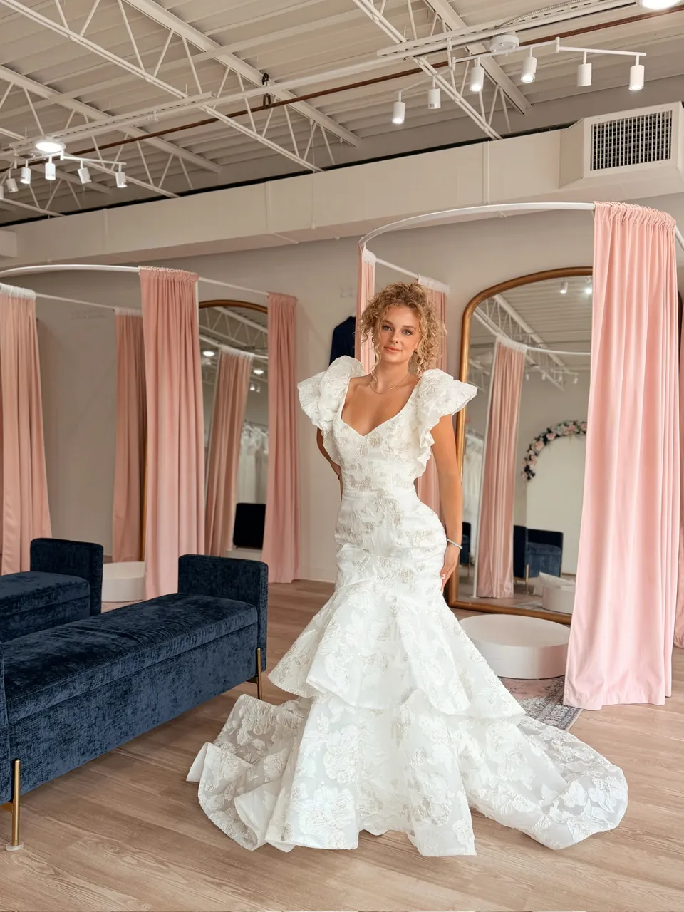 Lace mermaid wedding dress with ruffled flutter sleeves and a tiered skirt