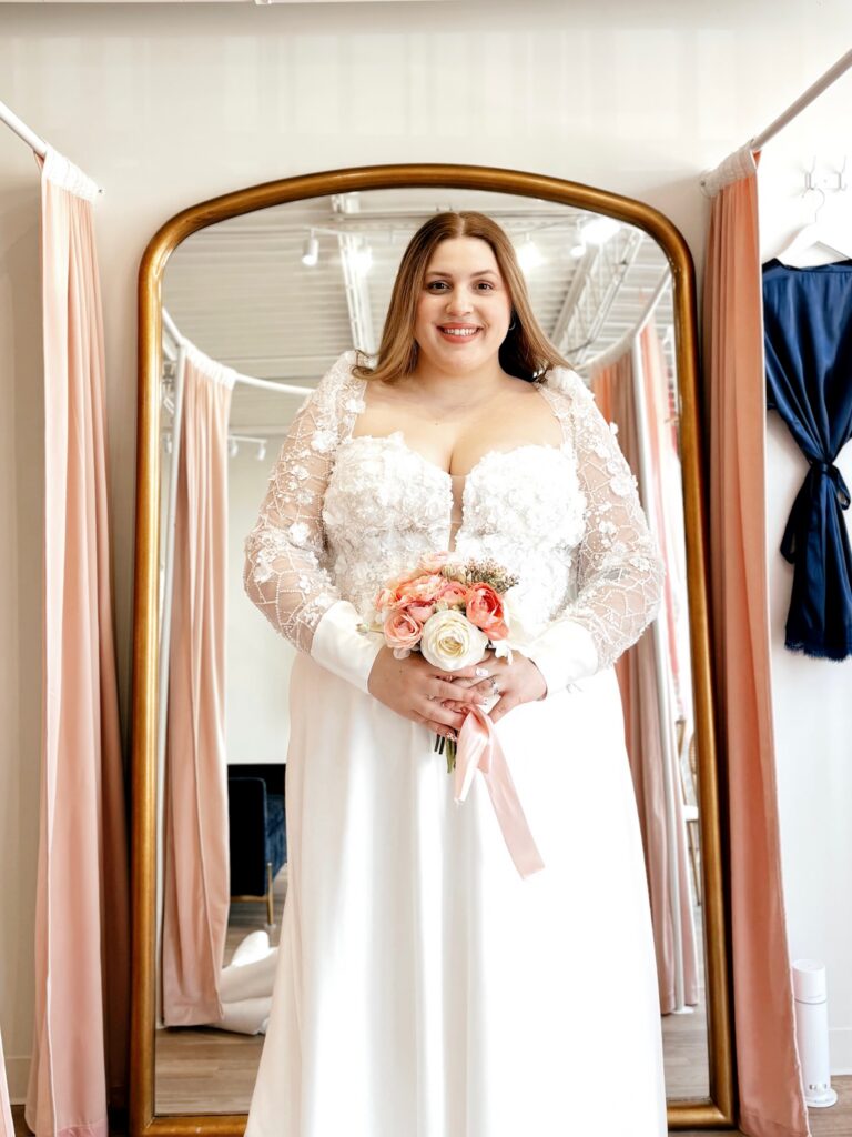 smiling curvy bride saying yes to the dress at vow ready.