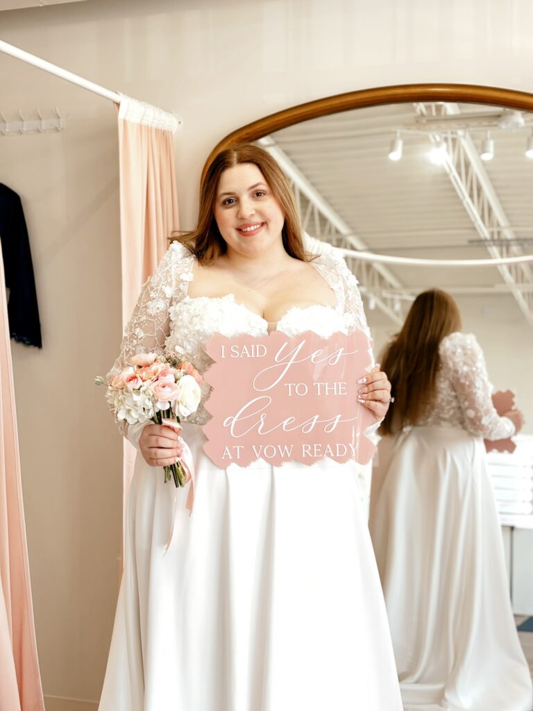 smiling curvy bride saying yes to the dress at vow ready.