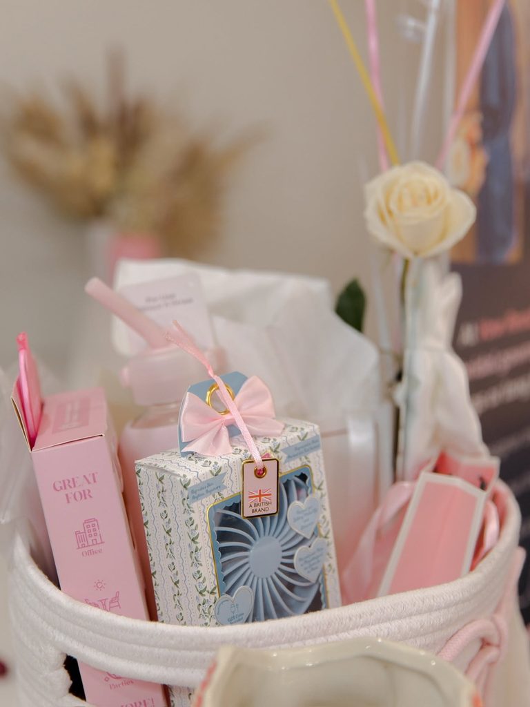 Pink-themed gift basket and party favors displayed at the Vow Ready grand opening event.