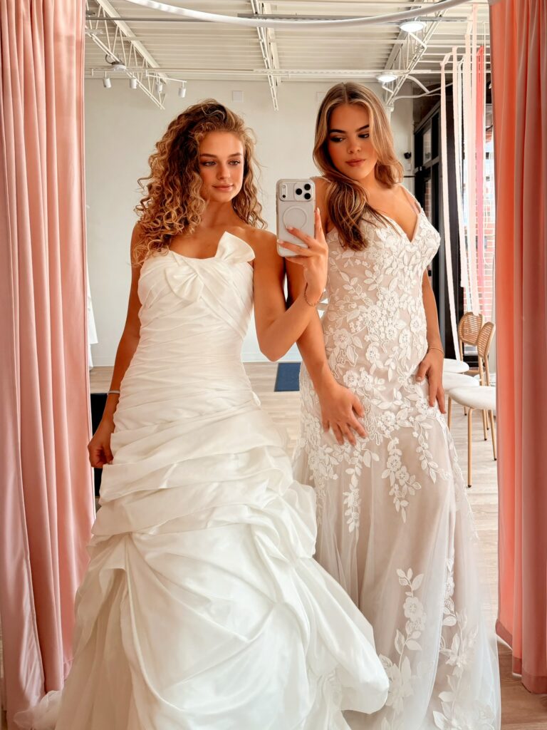 Two models wearing off-the-rack wedding dresses at Vow Ready.