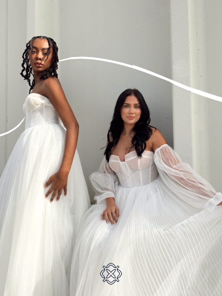 Two models wearing modern tulle wedding gowns at Vow Ready.